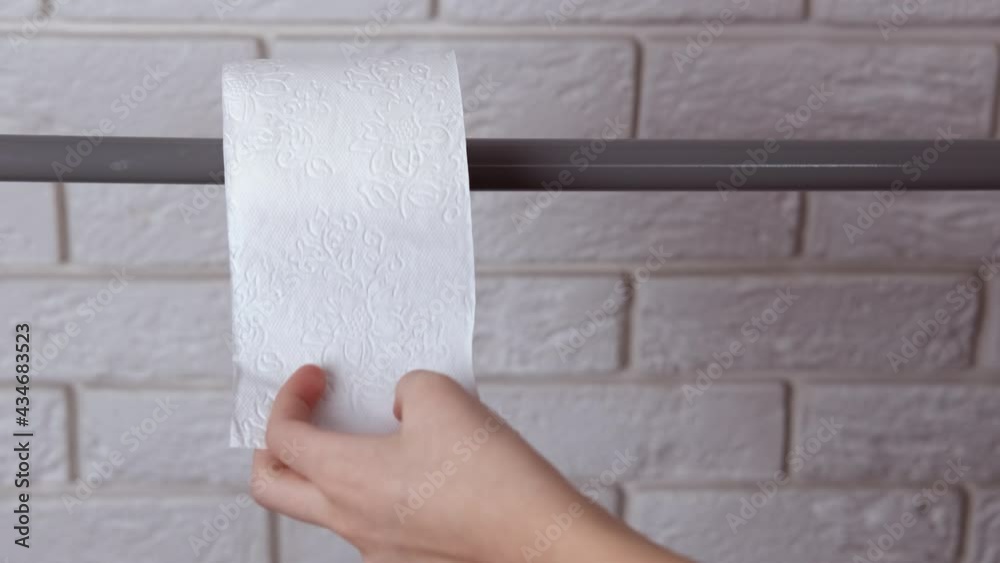 Health problem in the toilet. A view of a teen hand hold a toilet paper in the bathroom. Health problem in the toilet. A view of a teen hand hold a toilet paper in the bathroom.
