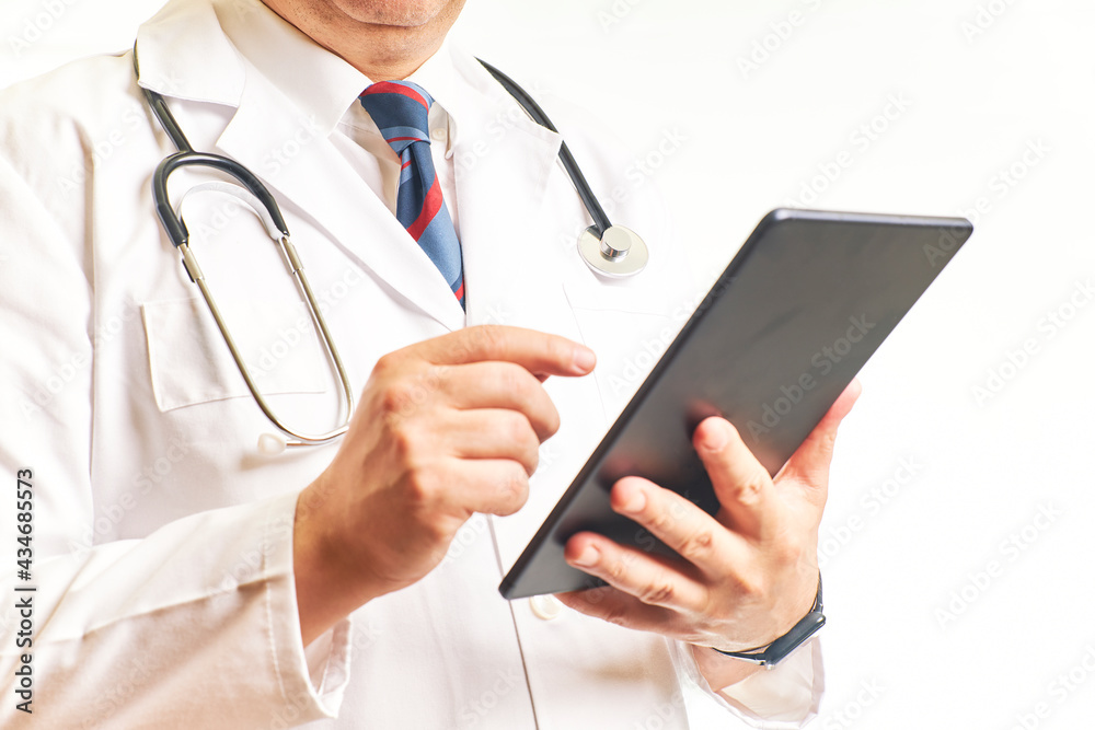 Doctor consulting the tablet to view patient data. Health concept Doctor consulting the tablet to view patient data. Health concept
