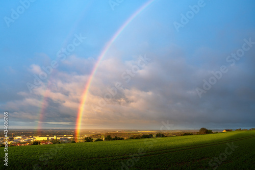 Hochsträß on the Mountain Kuhberg in Ulm with rainbow over the valley of Donautal, agriculture in foreground