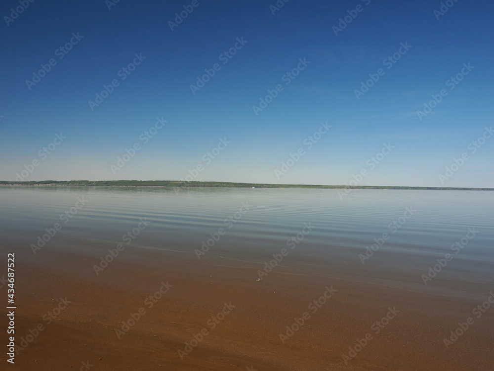 Dry cargo ship sailing on a large river. The photo was taken without magnification. Perm region, Russia