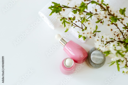 Face serums in pink glass containers. Cream  natural spa cosmetics. copy space