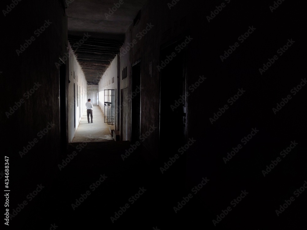 A man walking in Empty Walkway in an old school corridor in an Indian village Bihar