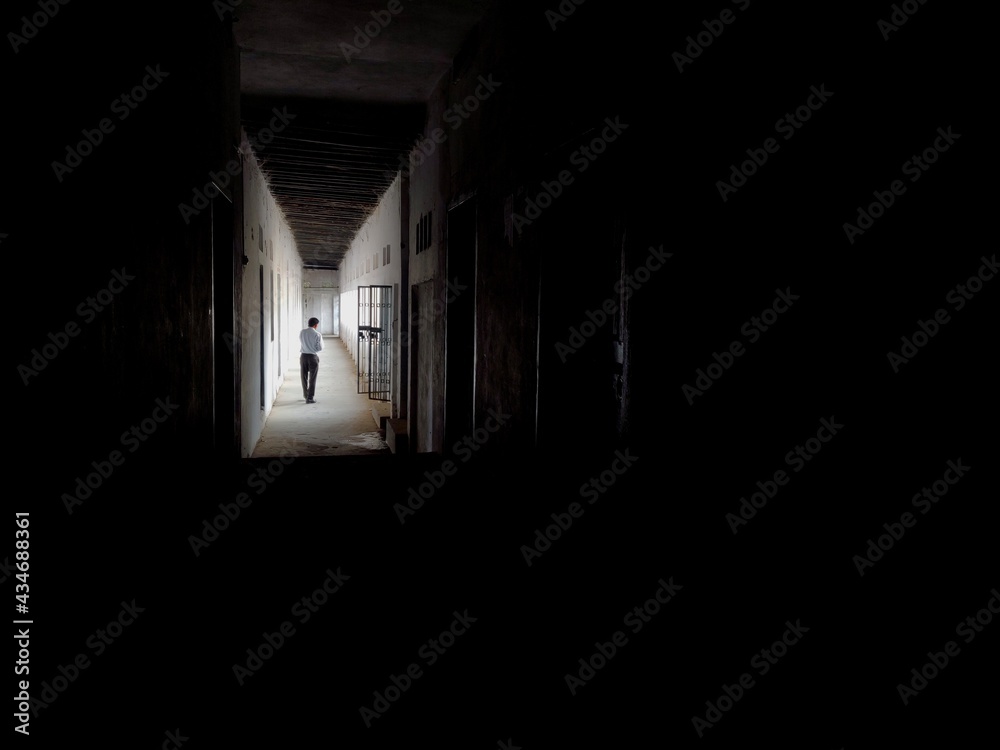 A man walking in Empty Walkway in an old school corridor in an Indian village Bihar A man walking in Empty Walkway in an old school corridor in an Indian village Bihar
