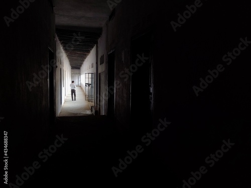 A man walking in Empty Walkway in an old school corridor in an Indian village Bihar