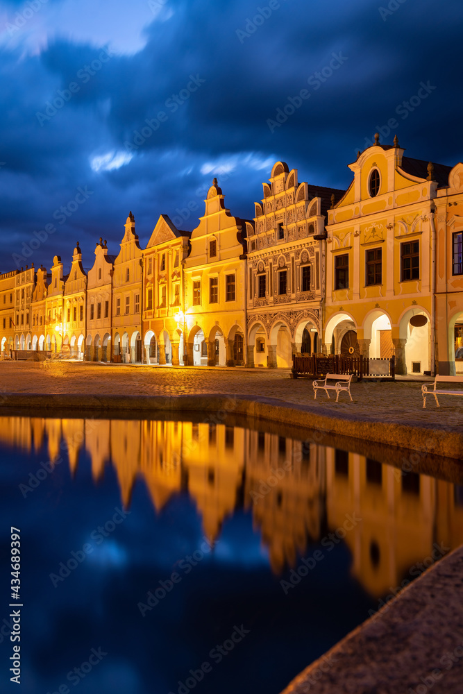 Row of traditional houses in the town of Telč, Czech Republic, at night. These houses on the main square are UNESCO heritage site. Row of traditional houses in the town of Telč, Czech Republic, at night. These houses on the main square are UNESCO heritage site.