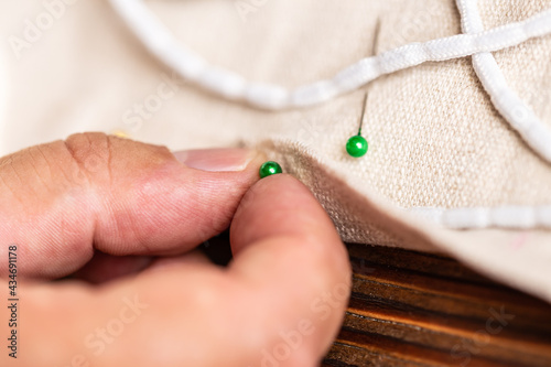 closeup from man hand with sewing pins
