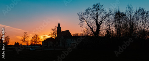 Beautiful sunset with a church silhouette near Kurzenisarhofen, Bavaria, Germany