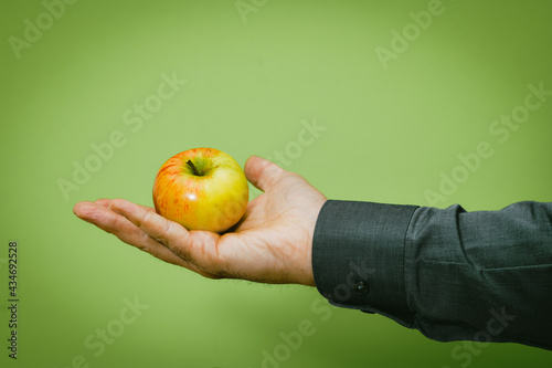 Männerhand bietet Apfel an