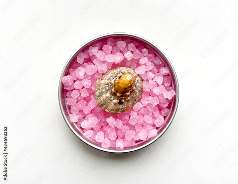 Sea thematic picture.  Here's one small shell located on the pink seasalt.