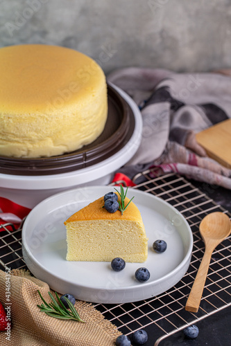 Slice of delicious Taiwanese castella cake with blueberry topping on white plate.