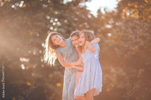 Three little girls spending time together in the park.
