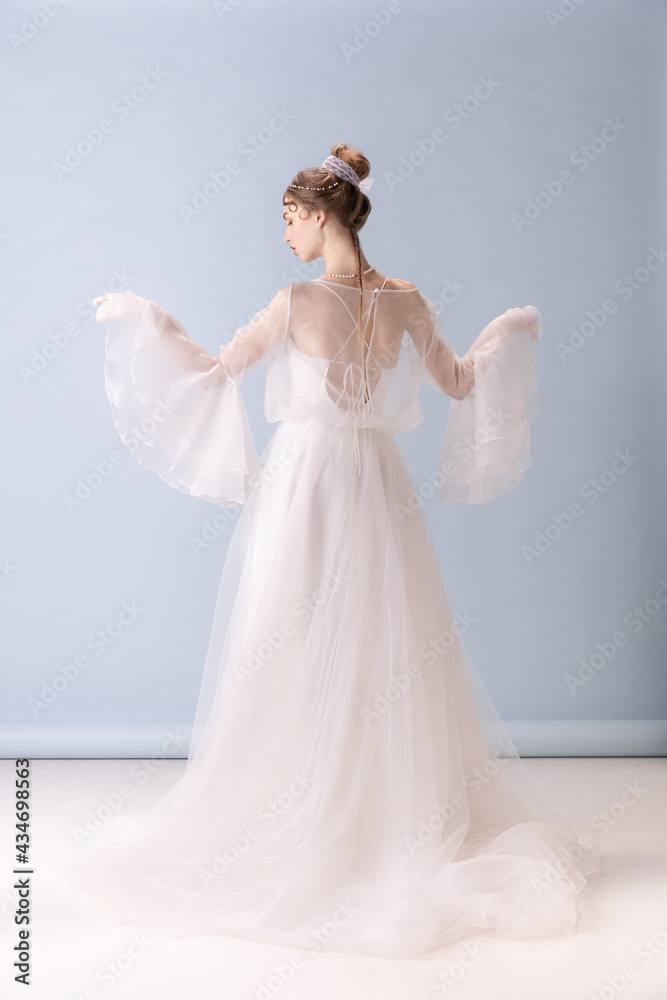 Young woman in art action isolated on white background. Retro style, comparison of eras concept. Young woman in art action isolated on white background. Retro style, comparison of eras concept.