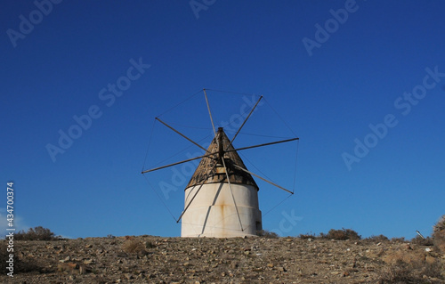 Windmill of the Cabo de Gata nature park, Spain, with blue sky.