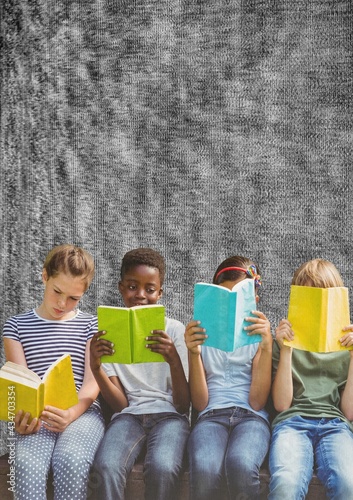 Composition of group of schoolchildren reading holding books on grey background