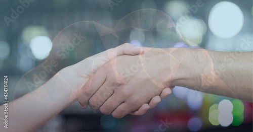 Cloud icon against mid section of two people shaking hands against spot of light