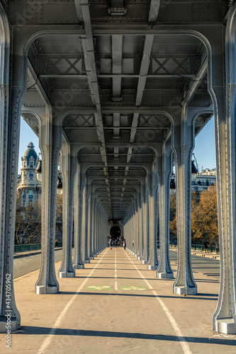 Paris, France - May 10, 2021: Panorama view of old historic Pont de Passy Bir-Hakeim steel arch bridge viaduct symmetry tunnel over Seine river in Paris
