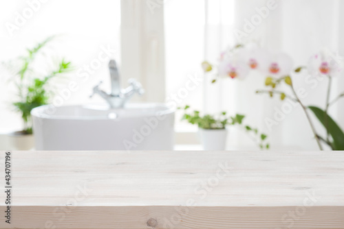 Photographie Wooden tabletop for product display on blur bathroom interior background