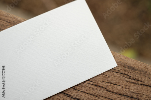White paper business card prototype placed on wood board background
