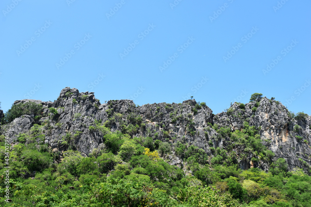 Limestone mountains on blue sky background Limestone mountains on blue sky background