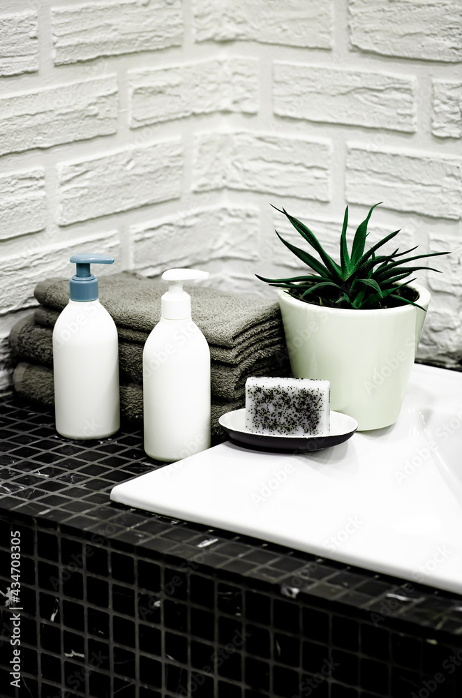 Towels with Liquid Soap on Table in Bathroom.  Mockup for Bathing Products in the Bathroom. Spa Shampoo, Shower Gel, Liquid Soap. Beauty Care Accessories for Bath.