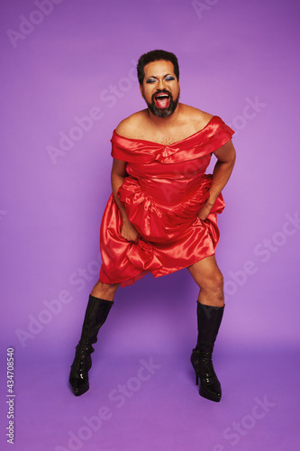 Gender queer male performing on purple background