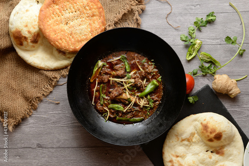 Chicken karahi with roghni naan and salad, desi food in Lahore Pakistan, asian spicy food, boneless chicken karahi
 photo