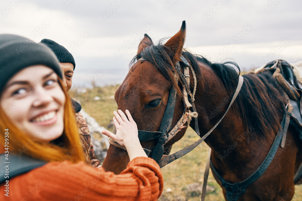 Obraz premium woman hiker with backpack rides a horse travel lifestyle