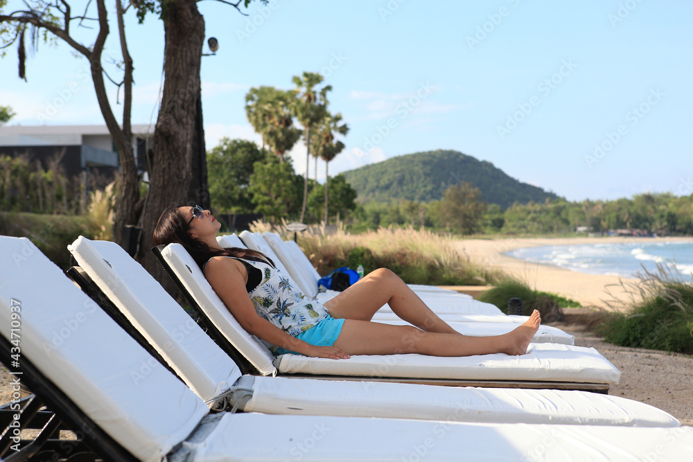 Summer day lifestyle woman relax  at the beach resort outdoors the hotel. Vacations and Summer Concept