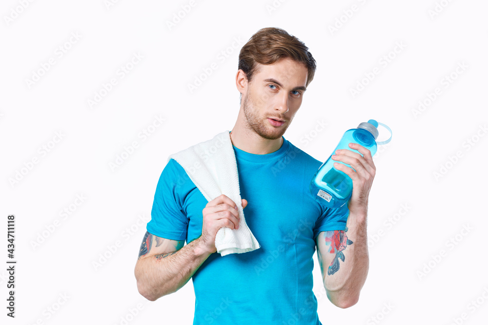 man in blue t-shirt holding bottle fitness cropped view