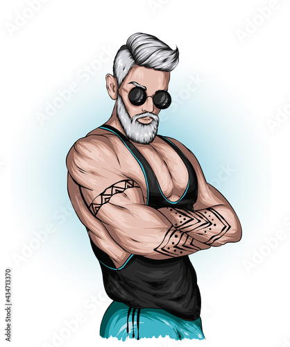 Handsome muscular guy in a stylish T-shirt and glasses.
