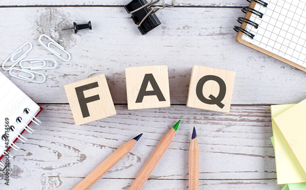FAQ text on wooden block with office tools on the wooden background - obrazy, fototapety, plakaty 