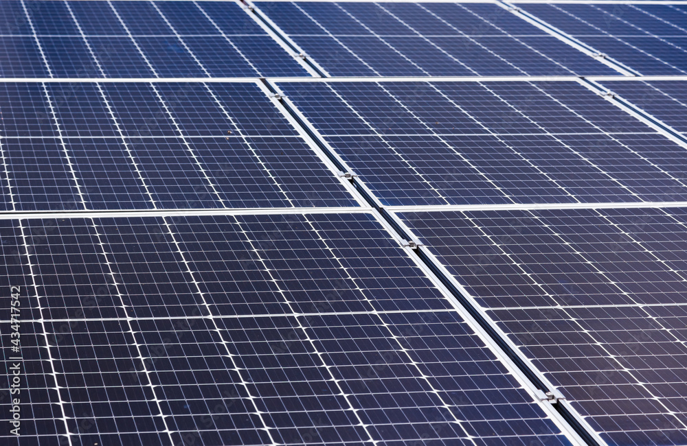 Solar panels on the roof of a house close-up. The solar panels are stacked close to each other. Solar panels on the roof of a house close-up. The solar panels are stacked close to each other.
