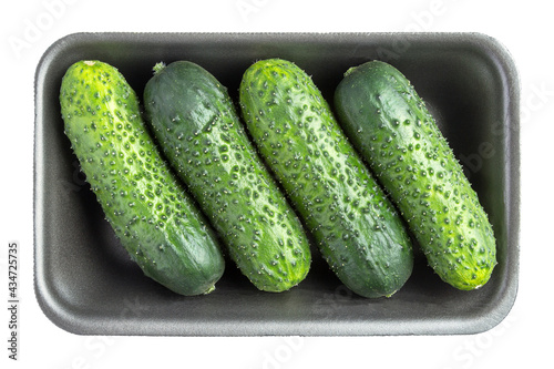 Four cucumbers in the black plastic container isolated on white