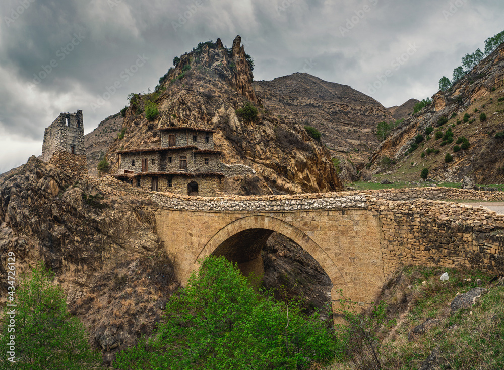 Dramatic mountain scenery with old stone bridge in dark rainy day. Dramatic mountain scenery with old stone bridge in dark rainy day.