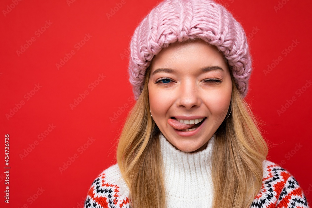 Closeup photo of beautiful happy sexy smiling young blonde woman standing isolated over colourful background wall wearing everyday trendy clothes looking at camera showing facial emotions Closeup photo of beautiful happy sexy smiling young blonde woman standing isolated over colourful background wall wearing everyday trendy clothes looking at camera showing facial emotions