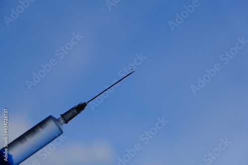 syringe on blue background