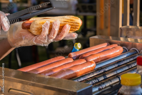 Sausages are fried on a rotary cooking machine
