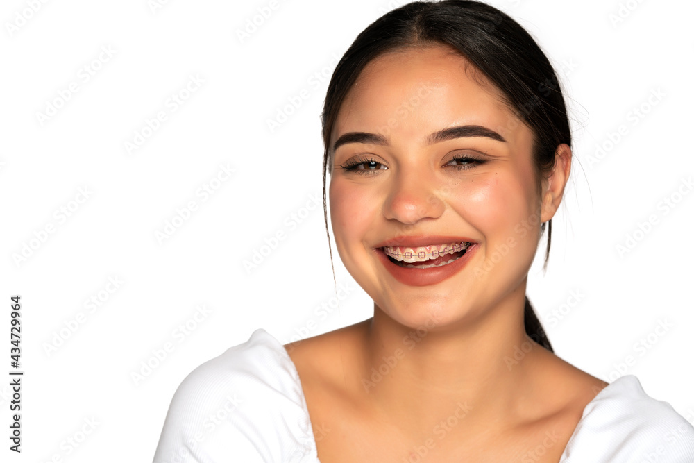 portrait of a young beautiful woman with braces laughing portrait of a young beautiful woman with braces laughing