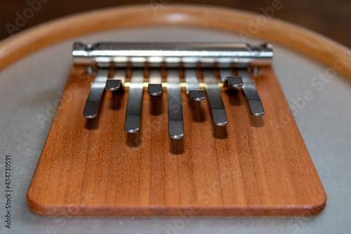 Nine metal keys of a wooden musical instrument kalimba or sansula close-up. 