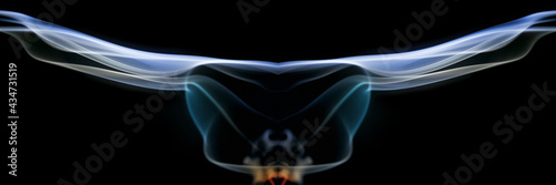 Colorful abstract Swirls of smoke against a black background that resemble an airplane