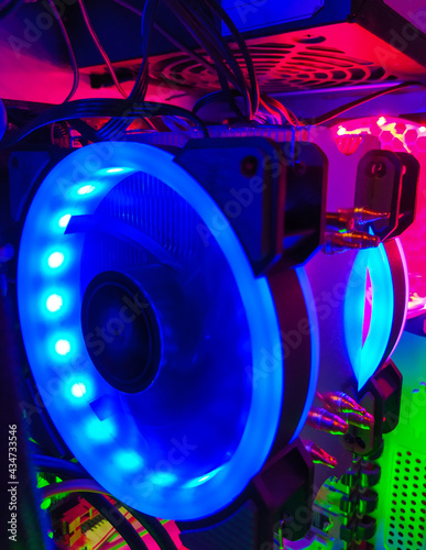 Modern computer air cooling with multi-colored led backlight-fans, cooling radiators, cables, boards, close-up, macro.