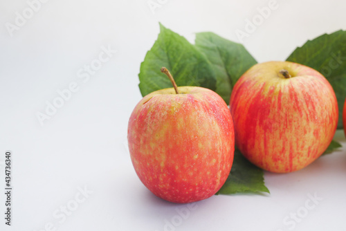 Close up of fresh apple with leaf on white background 