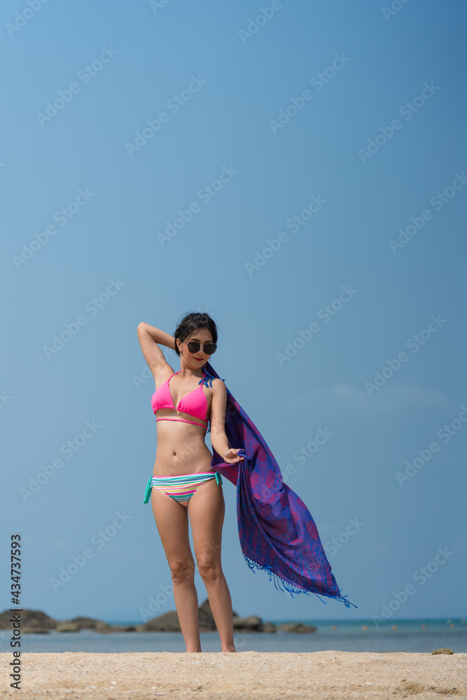 Portrait of thai woman posing outdoors at the sea beach