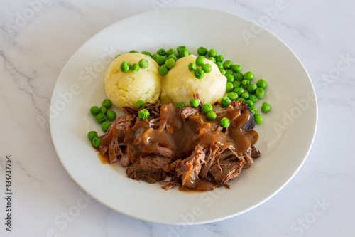 beef meat with gravy, mashed potatoes with green peas