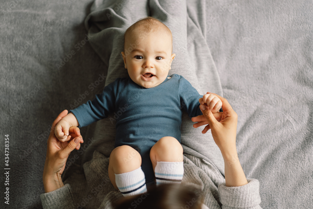 Fototapeta premium A young mother is play with little baby boy. Mother of a nursing baby