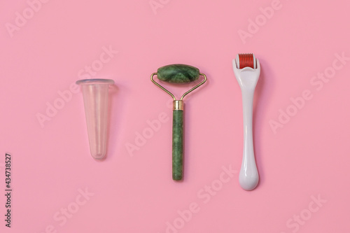 Trendy devices for home skincare: facial cupping, dermaroller, jade roller. Image with copy space, top view photo