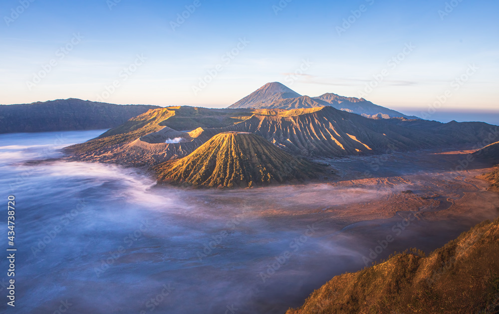 Mt.Semeru Mt.Bromo Mt.Batok , when the sunrise is lightly fog and the sky is beautiful. Smoke rising from the crater. , Indonesia Tengger Semeru national park.