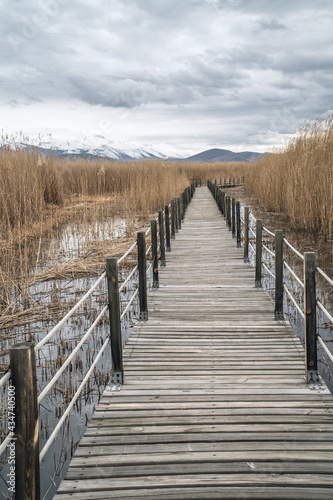Vertical view of a wooden bridge leading through marshes and lakes inside the Central Anatolian Sultan Reedy (Sultansazligi) National Park, Turkey © Jack Krier