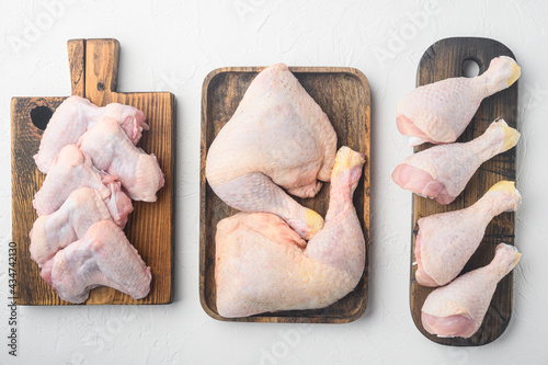 Fresh chicken meat cuts Farm poultry meat, on wooden cutting board, on white background, top view flat lay