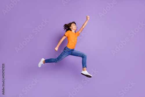 Full length body size view of attractive successful cheerful boy jumping striving isolated over violet purple color background